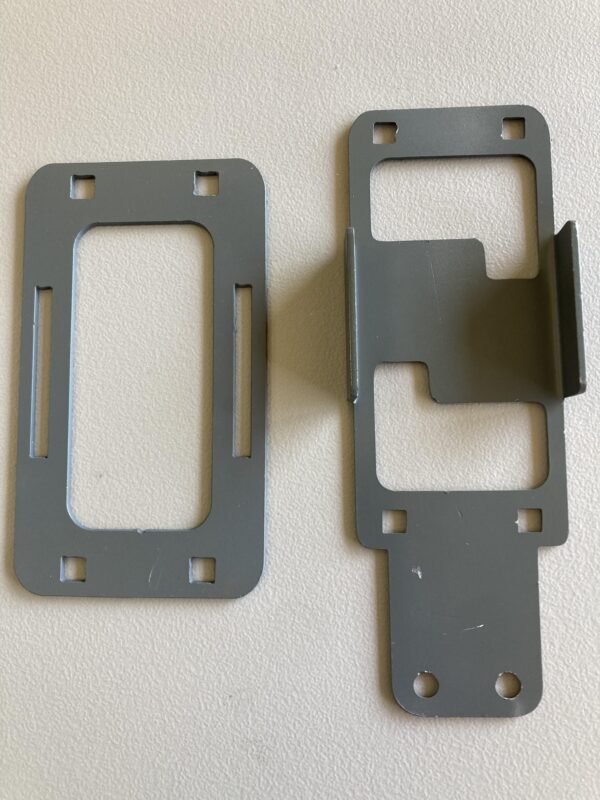 Two gray plastic Phone Mounts on a white surface.